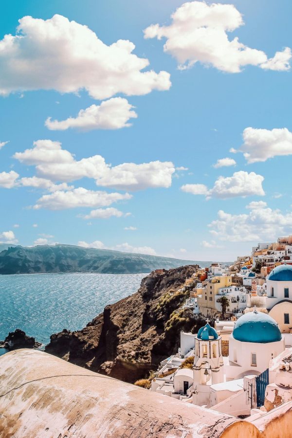 pexels-photo-1285625-1285625 Captivating view of Santorini's famous blue-domed buildings under a vibrant sky.