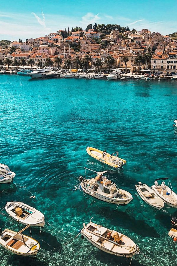 pexels-photo-2265876-2265876 Boats in the vibrant blue waters of Hvar, Croatia, showcasing a charming coastal town under sunny skies.